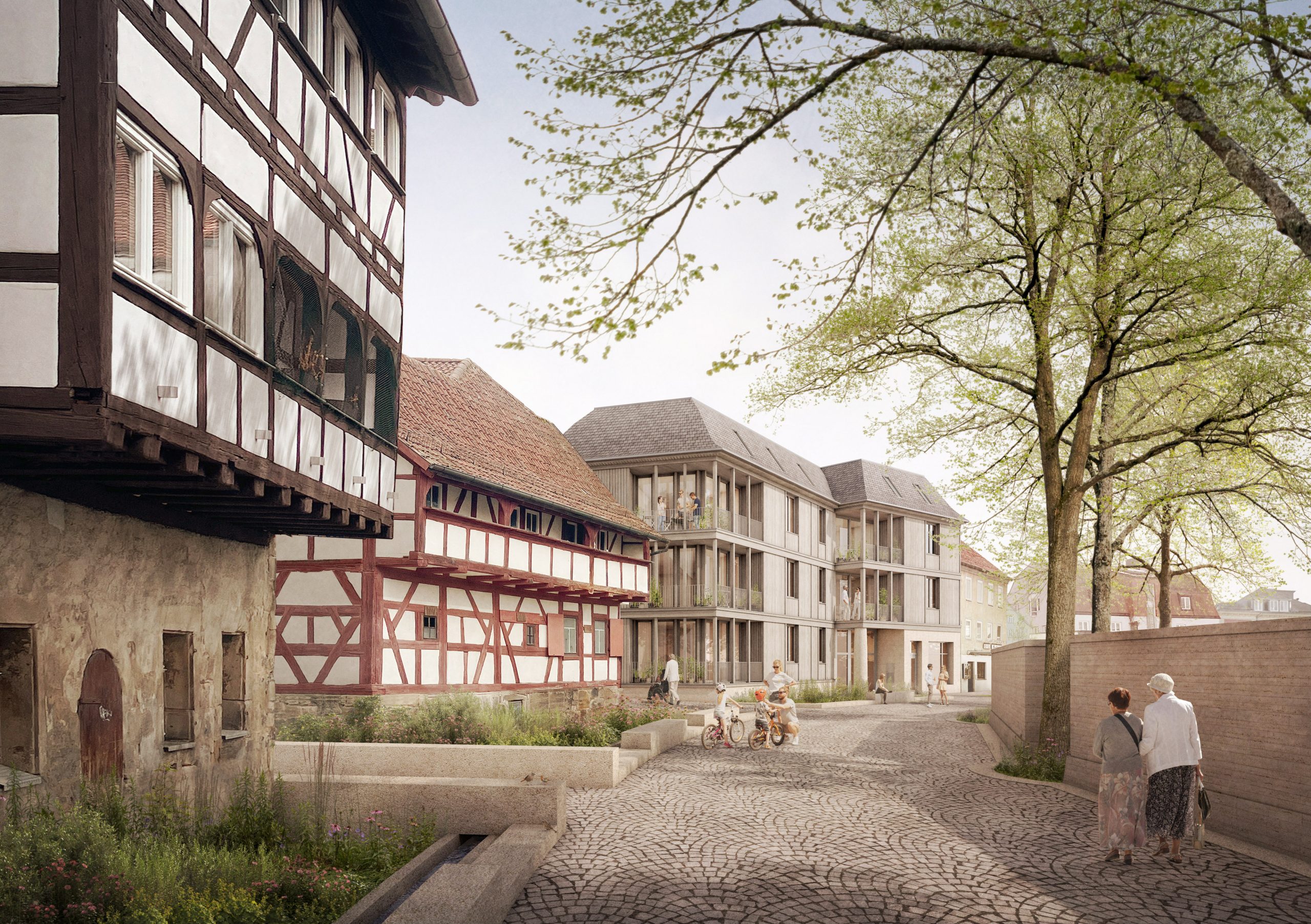 Visualisierung eines Mehrgenerationen-Wohnquartiers mit modernen Wohnhäusern neben historischen Fachwerkgebäuden, Menschen auf einer gepflasterten Straße und großen Bäumen.